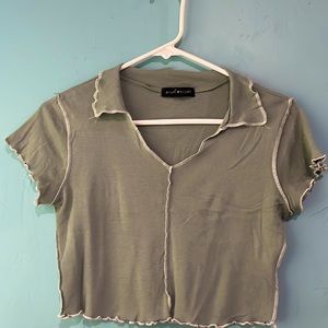 Green crop shirt with white stitching. Size: Medium